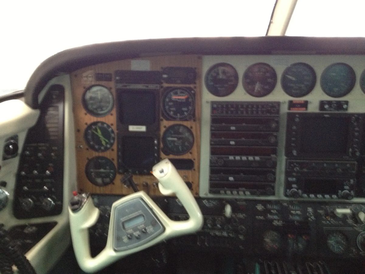 Original analog cockpit with steam gauges and wood grain panel